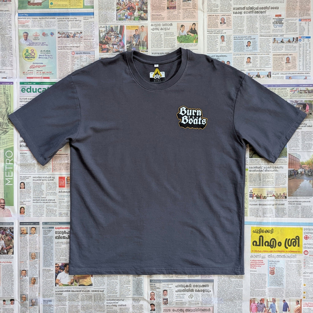 Grey oversized tshirt with 'Burn the Boats' text/logo in the front left chest area