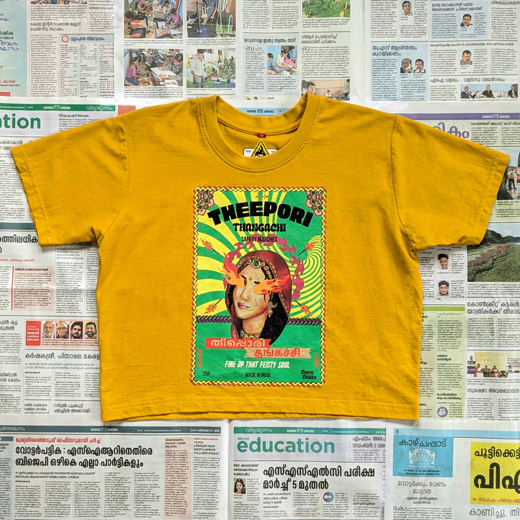 Mustard yellow crop top with a quirky matchbox style imagery on the front