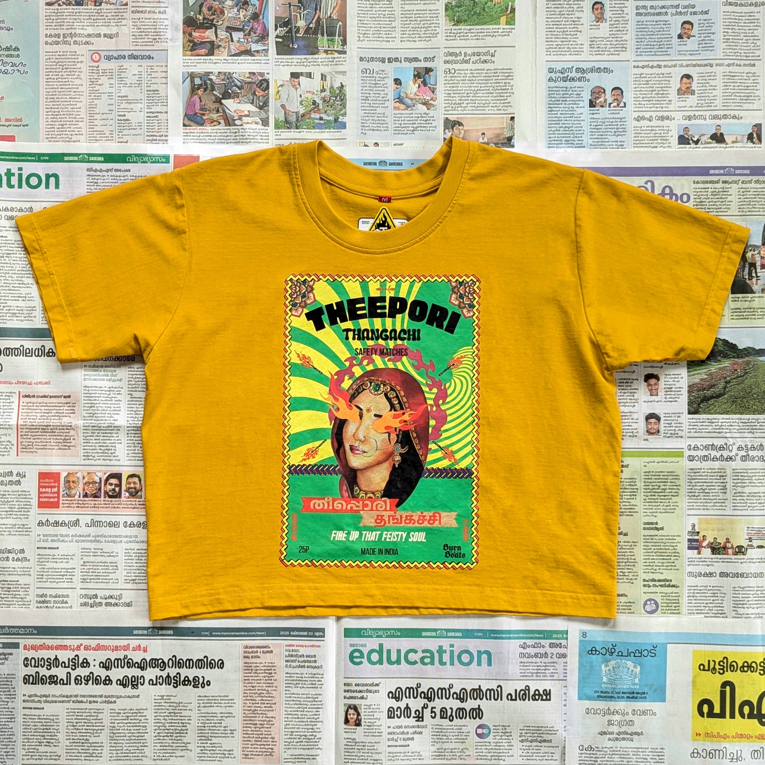 Mustard yellow crop top with a quirky matchbox style imagery on the front